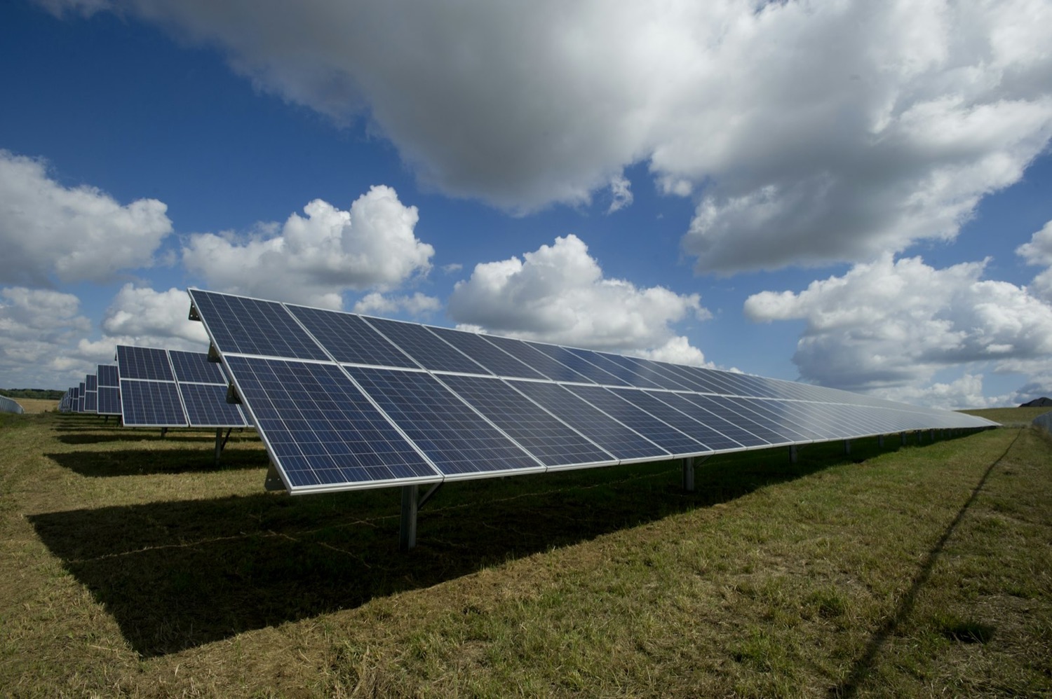 Solar panels under a bright sky